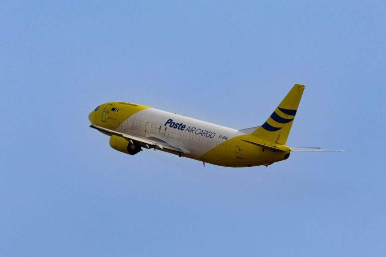 Air cargo plane taking off into a clear sky